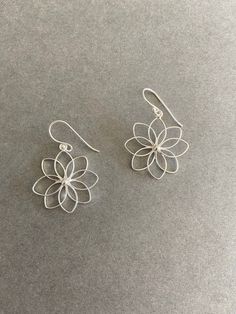 Sterling Silver Flower Dangle Earrings - Sterling Silver ★ Quantity : One Pair ★ Color : Silver ★ Materials : Sterling Silver ★ Size : 35mm ★ Flower Size : 25mm ★ Suitable for delicate and sensitive ears. ★ All purchases come in a small gift box perfect for gift giving. Multiple items will be boxed together. If you need extra boxes for gifting....just let us know! Minimalist Drop Earrings For Spring, Silver Flower Shaped Earrings For Spring, Silver Flower Earrings For Spring, Silver Drop Earrings For Spring, Spring Flower Earrings In Silver, Nickel-free, Spring Sterling Silver Earrings With Flower Charm, Nickel-free Silver Flower Earrings For Spring, Sterling Silver Drop Earrings For Spring, Spring Silver Flower Earrings Nickel Free