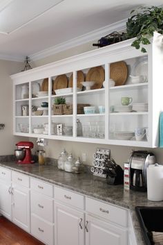 a kitchen counter with lots of dishes on it