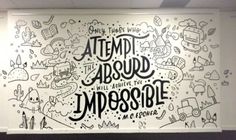 a large mural on the wall in an office with black and white lettering that reads, attempt about impossible