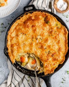 a chicken pot pie in a cast iron skillet with a serving utensil