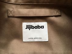 a label on the back of a jacket that says jilliba in black and white