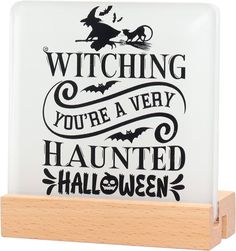 a glass plaque that says, witching you're a very haunted halloween