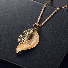 Unique nature-inspired pendant necklace featuring sparkling cubic zirconia and gleaming 18k gold-plated metal. Comes with coordinating drop earrings. Includes 18k gold-plated drop earrings and 18k gold-plated pendant necklace (three pieces total) Chain : 15.75" L with 1.96" extender Pendant : 0.55" W x 1.06" H Earrings: 0.91" W x 1.96" L Lobster claw clasp 18k gold-plated copper / cubic zirconia H Earrings, Earrings Pendant, Fashion Jewelry Sets, Rhinestone Decor, Special Jewelry, Wedding Jewelry Sets, Rhinestone Necklace, Rhinestone Earrings, Necklace Earring Set