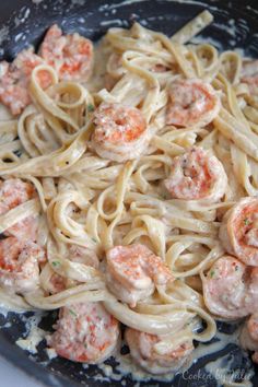 pasta with shrimp and cream sauce in a skillet