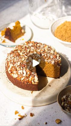 a cake on a plate with nuts around it