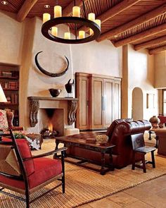 a living room filled with furniture and a fire place in the middle of a room