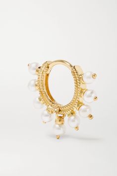 Maria Tash's passion for body piercings was sparked by the Indian and Pakistani designs she saw while studying in London. This hoop earring is crafted from 14-karat gold and edged with an intricate milgrain pattern. It features a halo of lustrous pearls and a single charm in the center that allows for the hinge to open and close easily.  Shown here with: [Jil Sander Shirt id868849],  [Maria Tash Earring id724336], [Maria Tash Earrings id724337], [Maria Tash Ear cuff id724341], [Maria Tash Earrin Classic Huggie Jewelry With Pearl Charm, Dainty Yellow Gold Hoop Earrings With Pearl, Gold Plated Small Hoop Pearl Charm Jewelry, Small Hoop Gold-plated Jewelry With Pearl Charm, Yellow Gold Pearl Huggie Earrings, Fine Jewelry White Small Hoop Earrings, Classic Pearl Huggie Jewelry, White Small Hoop Fine Jewelry, White Small Hoop Pearl Chain Jewelry