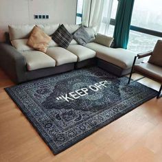 a living room with a large rug on the floor and a couch in front of it