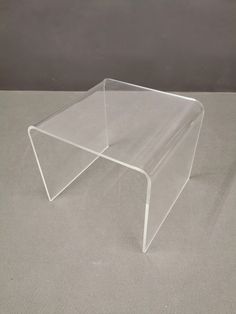 a clear plastic table on a gray surface