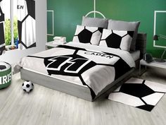 a soccer themed bedroom with green walls and white flooring is pictured in this image