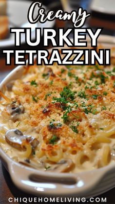 creamy turkey tetrazzini with mushrooms and parsley in a white casserole dish