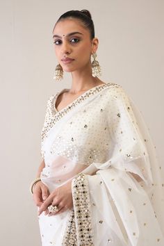 Pearl white saree with scattered metal beads and sequin embroidery. Paired with an embroidered unstitched blouse piece. - Aza Fashions Elegant White Pre-draped Saree For Eid, Festive White Pre-draped Saree With Cutdana, White Pre-draped Saree With Zari Work For Eid, White Chanderi Pre-draped Saree For Celebration, Elegant Chinon Blouse With Mirror Work, Elegant Chanderi Dupatta With Sequins, White Silk Pre-draped Saree With Zari Work, Elegant Navratri Blouse Piece With Mirror Work, Elegant Mirror Work Blouse Piece For Navratri