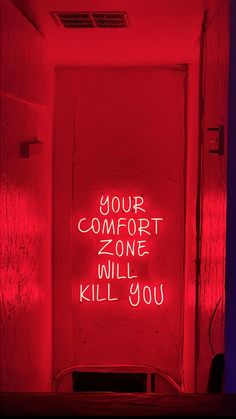 a red room with the words your comfort zone will kill you written on the door