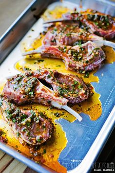 some meat is sitting in a pan with seasoning on it and ready to be cooked