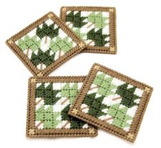 three coasters with green and white designs on them, one in the shape of trees