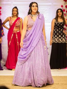 Embrace elegance and grace with the Samantha Lehenga. Crafted with intricate mirror, pearl, and stone embroidery work, this whimsical lehenga exudes a sense of grandeur, making it perfect for special events and occasions. Key Features: Precious mirror, pearl, and stone embroidery work Lavender color exuding beauty and grace Soft net fabric for a gorgeous and elegant look Elevate your style with the Samantha Lehenga, designed to bring out your innate grace and elegance. The silk blouse adorned wi Samantha Lehenga, Elegant Pre-draped Kundan Saree For Party, Traditional Drape Anarkali Set With Mirror Work For Reception, Anarkali Embellished Pre-draped Saree For Wedding, Anarkali Pre-draped Saree With Mirror Work, Pre-draped Saree With Mirror Work For Reception At Navratri, Mirror Work Anarkali Set For Reception, Mirror Work Pre-draped Saree For Navratri Reception, Elegant Chinon Lehenga For Festivals