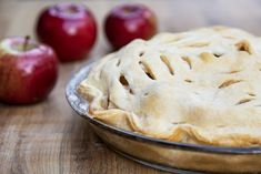 an apple pie sitting on top of a wooden table