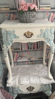 a small white table with flowers on it