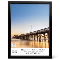 the ventura pier at sunset with water and sky in the background, as seen from across the bay