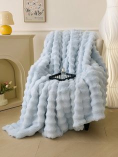 a blue blanket sitting on top of a wooden floor