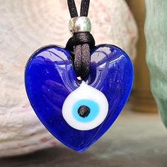 "EVIL EYE PROTECTION PROTECT YOUR LOVE NAZAR BONCUK In Turkey, it is known by the name nazar boncuğu (the latter word being a derivative of boncuk, \"bead\" in Turkic, and the former borrowed from Arabic), in Greece is known as μάτι (the evil eye). In Persian and Afghan folklore, it is called a cheshm nazar (Persian: چشم نظر) or nazar qurbāni (Persian: نظرقربانی). EVIL EYE HEART NECKLACE MADE IN THE TRADITIONAL TURKISH WAY. ONE SUPPLIED PICKED AT RANDOM FOR YOU ALL ARE UNIQUE. Pendant Diameter i Blue Heart Charm Necklace For Gift, Blue Necklace For Valentine's Day Gift, Spiritual Blue Jewelry With Heart Charm, Blue Spiritual Jewelry For Gifts, Spiritual Blue Jewelry Gift, Blue Jewelry With Heart Charm For Gifting, Blue Heart Charm Jewelry As A Gift, Blue Heart Charm Jewelry As Gift, Blue Heart Charm Jewelry For Gift