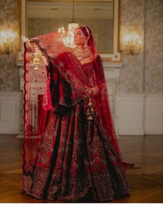 a woman in a red and black bridal gown