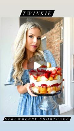 a woman holding a cake with strawberries on it and the caption twinklee