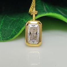 This elegant pendant features a 1.67-carat radiant-cut moissanite solitaire, showcasing its brilliant sparkle. The gemstone is bezel-set in 14k yellow gold, offering a secure and sleek design. This minimalist piece combines timeless charm with contemporary simplicity, making it a perfect accessory for women seeking a classic yet modern look. Bezel Set Moissanite Pendant 1.67 CT Radiant Cut Moissanite Solitaire Classic Pendant, 14k Yellow Gold Charm Minimalist Pendant For Womens Moissanite Pendan Square Cut Moissanite Jewelry For Gifts, White Rectangular Moissanite Jewelry, Rectangular White Moissanite Jewelry, Rectangular Moissanite Jewelry As A Gift, White Rectangular Jewelry With Single Diamond, Rectangular Gold Moissanite Jewelry, Rectangular Moissanite Gold Jewelry, Rectangular Yellow Gold Moissanite Jewelry, Minimalist Pendant