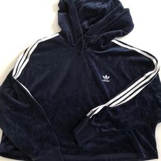 Velour Cropped Hoodie (Product Color: Collegiate Navy/White) Oversized Navy/Royal Blue Velvet Cropped Hoodie Embroidered Adidas Logo On The Chest 3 Stripes On Both Sleeves With Ribbed Cuffs Drawcord-Adjustable Hood No Pockets Measurements: Chest (60"), Length (19.5"), Sleeve From The Collar (~28") Open To Offers, No Trades Please. Adidas Sportswear Hoodie With Three Stripes, Adidas Sporty Tops For Loungewear, Sporty Adidas Tops For Loungewear, Adidas Blue Hoodie Sportswear, Blue Adidas Sportswear Hoodie, Blue Adidas Hoodie With Drawstring Hood, Adidas Sporty Winter Tops, Winter Athleisure Tops With Three Stripes, Athleisure Tops With Three Stripes For Winter