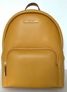 New with tags 100% Authentic Michael Kors  Erin Medium Backpack Marigold with Gold tone hardware Style # 35FOGERB2L The Erin backpack promises both style and function in a streamlined, easy-to-wear shape that’s designed for any lifestyle. Pebbled leather construction offers luxe texture, while the spacious interior will effortlessly stow everything from a tablet to a pair of flats. Pebble Leather 26"-30" adjustable shoulder straps Interior details: iPad compartment, back zip pocket and front sli Marigold Yellow, Michael Kors Handbag, Medium Backpack, Girly Shoes, Easy Trendy Outfits, Cute Accessories, Yellow Leather, Handbags Michael Kors, Style Accessories