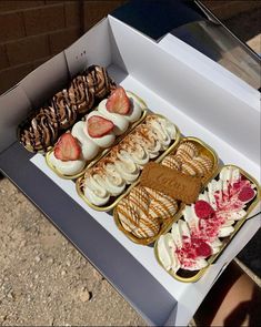 a box filled with lots of different types of desserts on top of each other