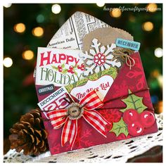 a close up of a christmas card with a pine cone on the table next to it