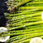 asparagus and lemons are on the grill