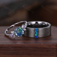 two wedding rings with blue opal and white diamonds