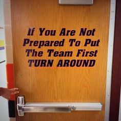 a sign on a door that says if you are not prepared to put the team first turn around