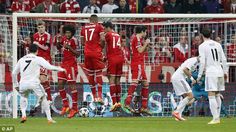 a group of men playing soccer against each other in front of a crowd watching the game