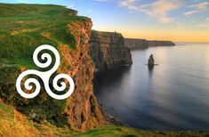 an aerial view of the ocean and cliffs with a white omen symbol on it