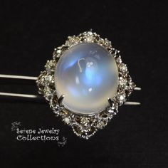 This large rare Moonstone Cabochon Ring is set in 14k solid gold and exhibits mesmerizing blue flash aduralescence. Scintillating diamonds surround this natural beauty! Ring Size: 5.75 Total Weight: 13.65 grams Precious Metal: 14k solid gold Precious stones: -Moonstone Center Stone: 18.5mm x 16.2mm, 23.05 carats -White Round Diamond: 0.4ct Celestial Round Moonstone Ring For Formal Occasions, Celestial Moonstone Ring For Formal Occasions, Formal Moonstone Ring With Gemstone Accents, Elegant Collectible Moonstone Ring, Wedding Moonstone Cabochon Diamond Ring, Unique Diamond Moonstone Ring, Unique Moonstone Diamond Ring, Unique Moonstone Gemstone Ring For Formal Events, Unique Moonstone Gemstone Ring For Formal Occasions