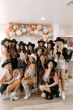 a group of women dressed in costumes posing for a photo