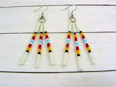 Tribal Seed Bead Earrings, Native Indian Inspired, Native American Style, Traditional Western Style Long dangle Native American beaded earrings accented with medicine wheel colors. Free Shipping First Class Mail with NO TRACKING! Matching Necklace ~ https://www.etsy.com/listing/753157143 💜Visit my store for more Awesome finds💜 https:www.etsy.com/shop/DJsWrapBracelets Southwestern Style White Jewelry With Dangling Beads, White Round Bead Southwestern Earrings, Southwestern Style White Beaded Dangle Earrings, Southwestern Tiny Beads Dangle Earrings, Native Anerican Earrings, Cherokee Beaded Earrings, Nickel-free Southwestern Style Festival Earrings, Southwestern Style Multicolor Nickel-free Beaded Earrings, Beaded Earrings Native