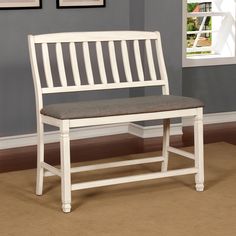 a white bench sitting in front of a window next to a brown carpeted floor