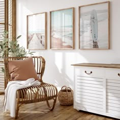 a chair and some pictures on the wall next to a table with a plant in it