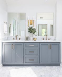 a large bathroom with two sinks and mirrors