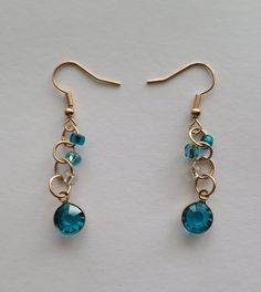 A pair of Gold, Blue, and White glass bead earings. The perfect gift for a friend or for yourself. Gift For A Friend, Handmade Wire Jewelry, Handmade Wire, Glass Bead, White Glass, Jewelry Ideas, Wire Jewelry, Jewelry Earrings Dangle, Glass Beads