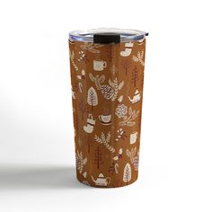 a coffee cup with leaves and animals on it, sitting in front of a white background