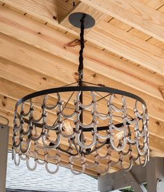 a chandelier hanging from a wooden ceiling