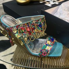 Shine On In The Azalea Wang Envie Multi Gemstone Jewel Drape Sandal. This Statement-Making Shoe Features A Glittery Textile Upper, An Open Square Toe Silhouette, Gem-Embellished Toe And Foot Bands, Rhinestone Link Draped Detailing, Faux Gold Hardware, A Cushioned Silver Metallic Faux Leather Insole, And A Slip-On Fit. Complete With A Slim, Gemstone-Adorned Stiletto Heel. Pair This Sparkling Style With All Black And Your Fave Statement Accessories For A Complete Look. (All Measurements Approximat Luxury Bedazzled Sandals For Party, Elegant Multicolor Rhinestone Heels, Elegant Embellished Multicolor Sandals, Elegant Multicolor Embellished Sandals, Luxury Multicolor Sandals For Party, Multicolor Embellished Evening Sandals, Glamorous Multicolor Sandals For Party, Embellished Multicolor Evening Sandals, Designer Multicolor Sandals For Party