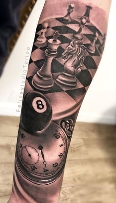 a man's arm with a clock and chess pieces on it, as well as the number eight