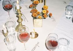 a table topped with wine glasses and candles