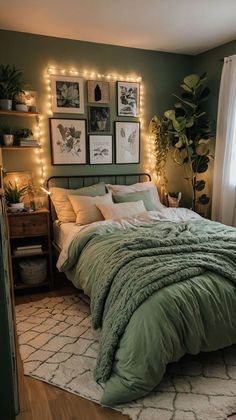 a bedroom with green walls and pictures on the wall above the bed, along with lights